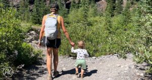 mom and son hiking on a trail